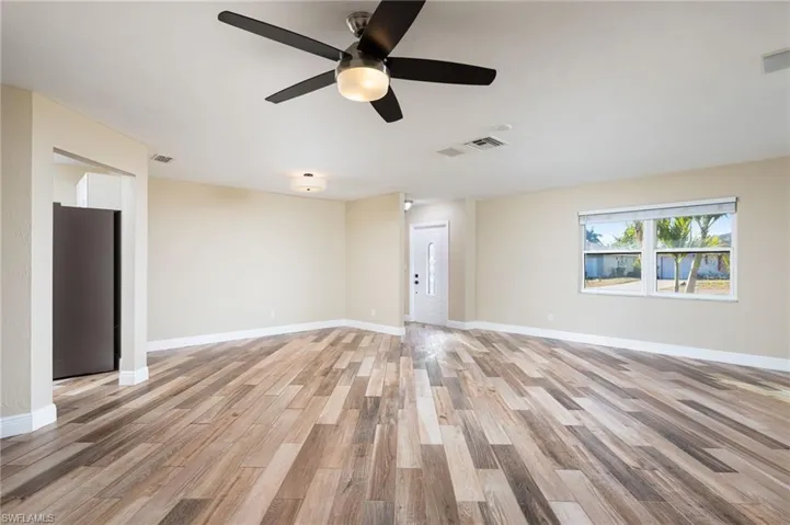 Living area with wood plank tile flooring . View towards front entry.
