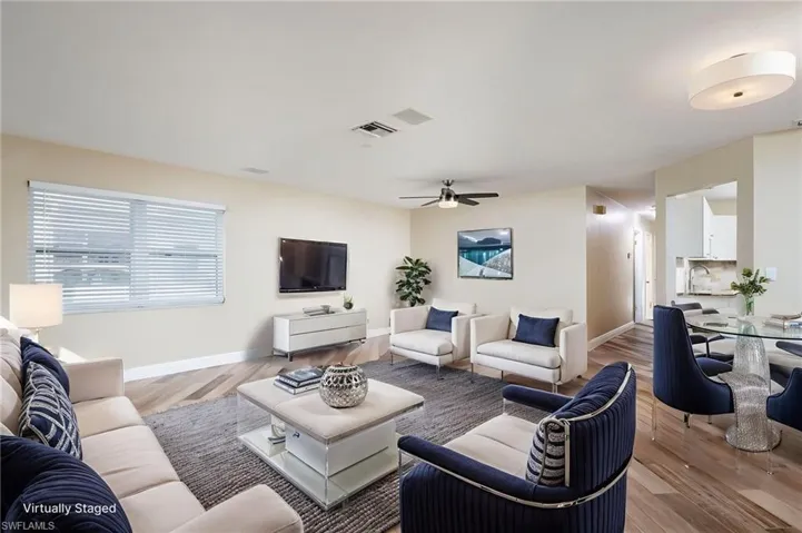 View from front entry into Living room with wood plank tile flooring and freshly painted interior.