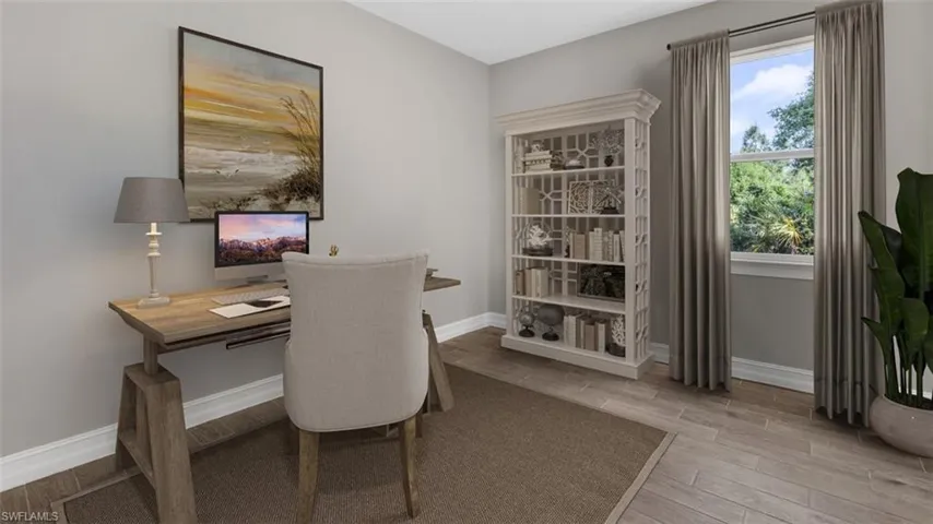 This image is virtually staged. Office with wood tiled floors and baseboards
