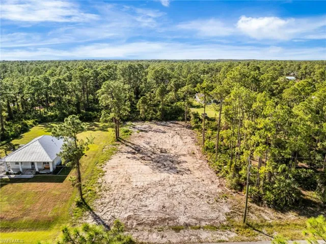 View of subject property featuring a heavily wooded area