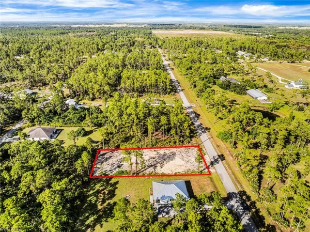 View of property location featuring property boundaries highlighted and a forest