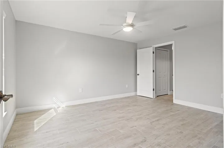Unfurnished room featuring ceiling fan and light hardwood / wood-style floors