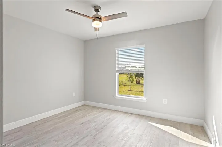 Spare room with ceiling fan and light hardwood / wood-style flooring