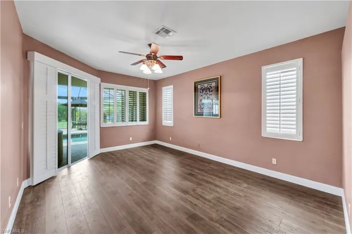 Spare room featuring visible vents, a ceiling fan, and baseboards