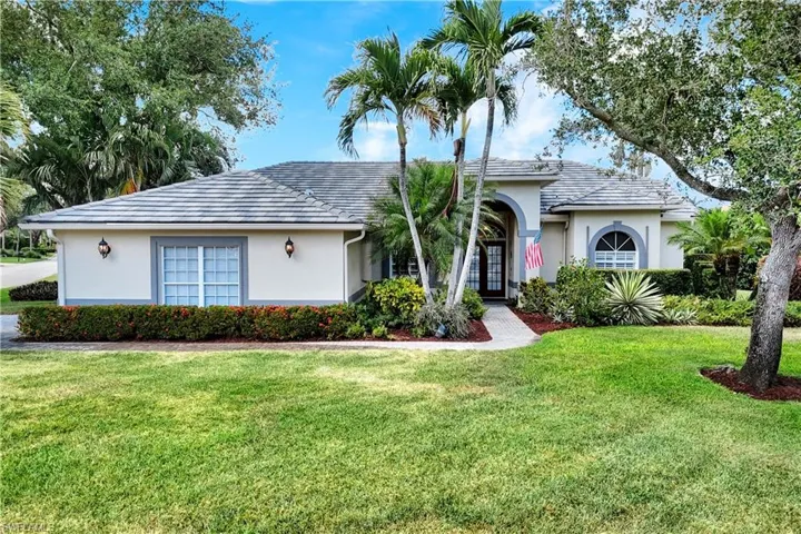 Single story home featuring french doors, a front lawn, and stucco siding