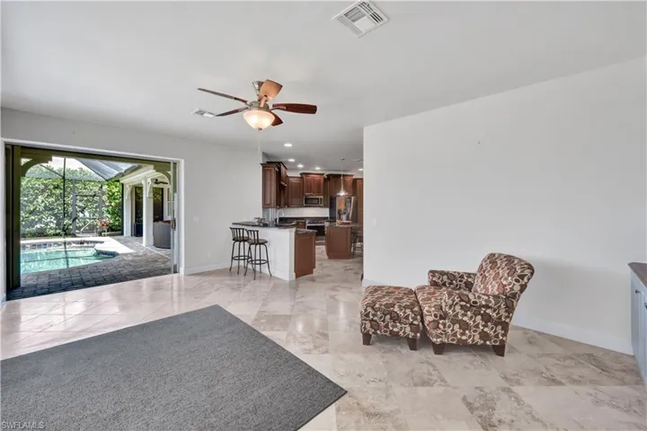 Living room featuring recessed lighting, a ceiling fan, visible vents, and baseboards