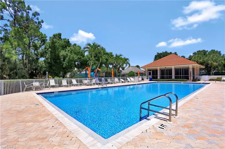 Community pool with fence and a patio