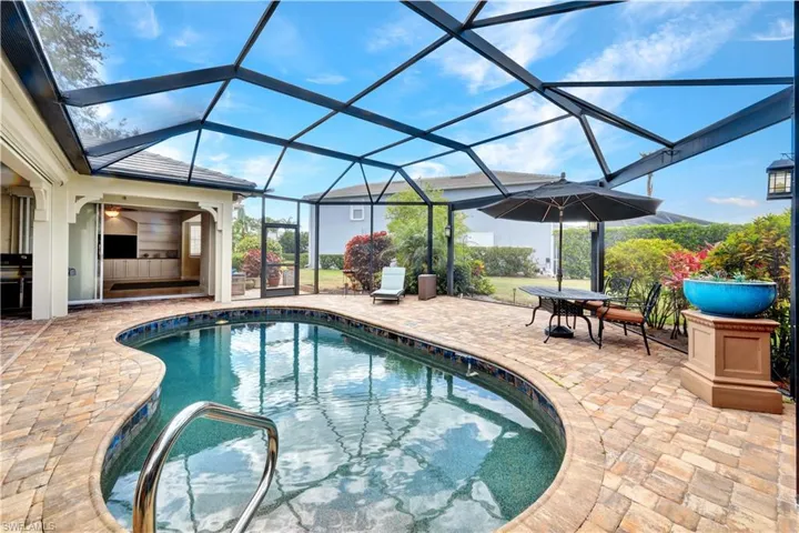 Outdoor pool featuring a patio, outdoor dining space, and a lanai