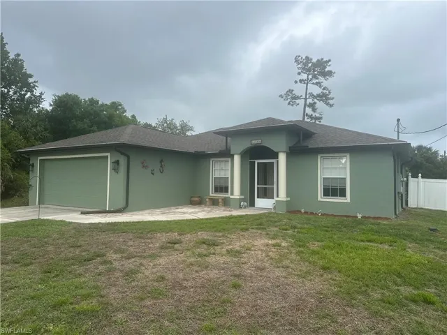 Ranch-style home with an attached garage, a patio, stucco siding, roof with shingles, and driveway