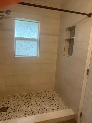 Full bathroom featuring a shower stall