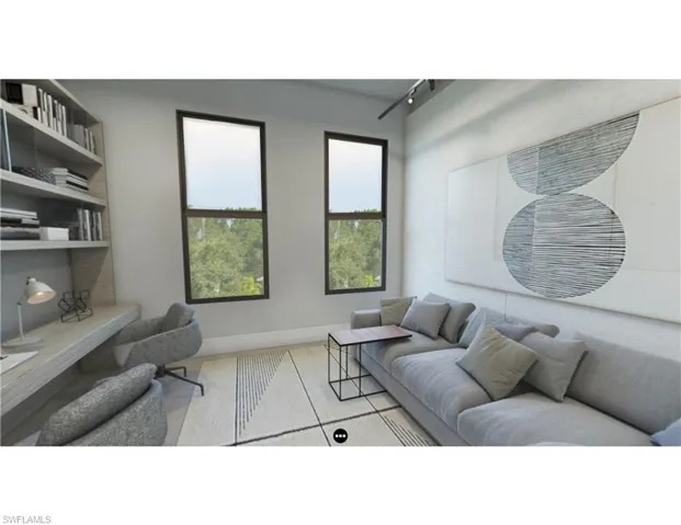 Living room featuring rail lighting and baseboards