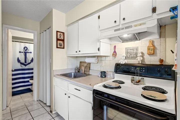 Additional storage in the pantry shown to the left of the kitchen sink.
