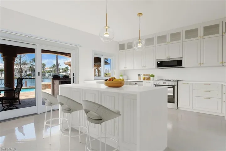 Kitchen area leading to the patio. This photo has been virtually staged.