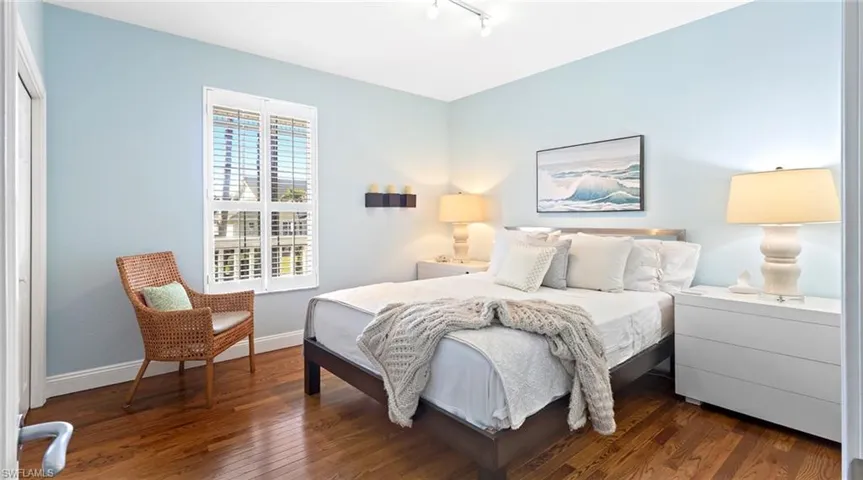 Bedroom featuring dark wood finished floors and rail lighting