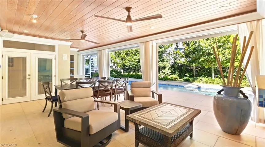 View of patio featuring an outdoor pool, ceiling fan, an outdoor hangout area, and french doors
