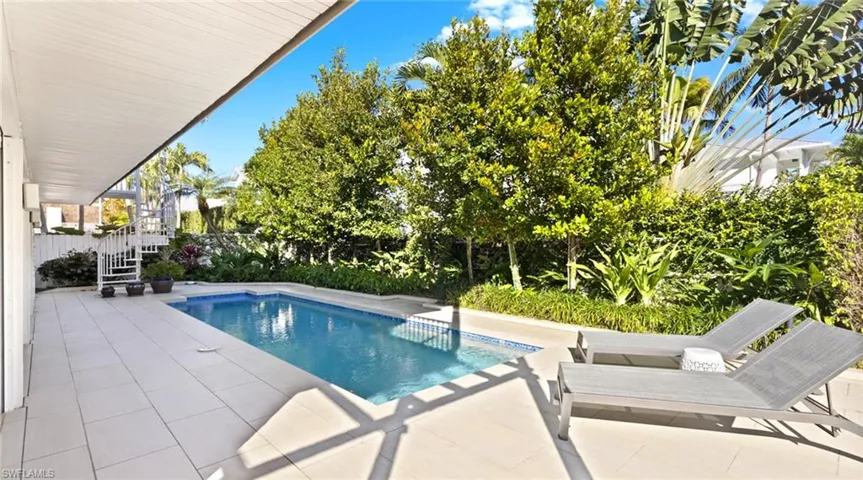 Outdoor pool with a patio and a fenced backyard