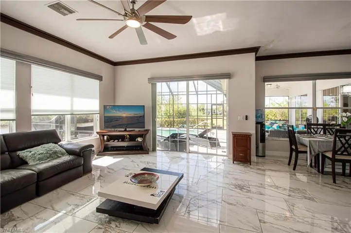 family room looking out towards the lanai and eat in kitchen area