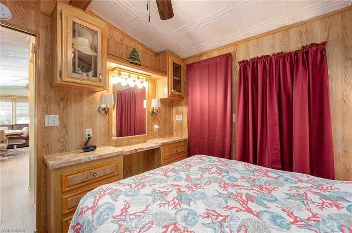 Bedroom with ceiling fan and storage area for clothes