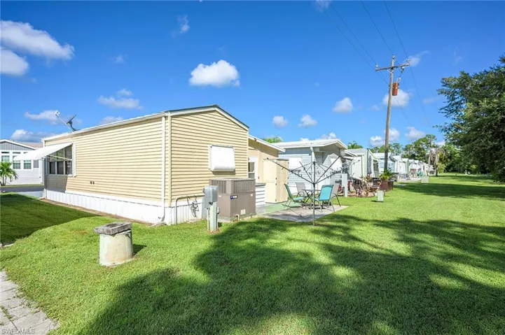View of property exterior featuring a lawn