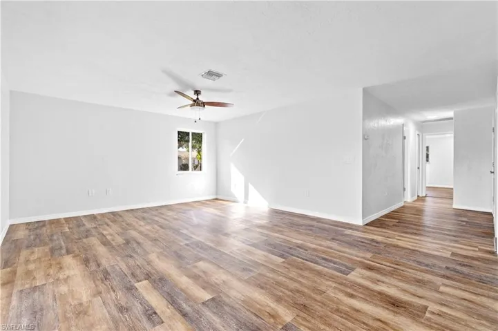 Empty room with light wood-type flooring and a ceiling fan