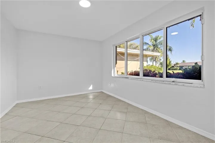 Unfurnished room featuring baseboards and light tile patterned floors