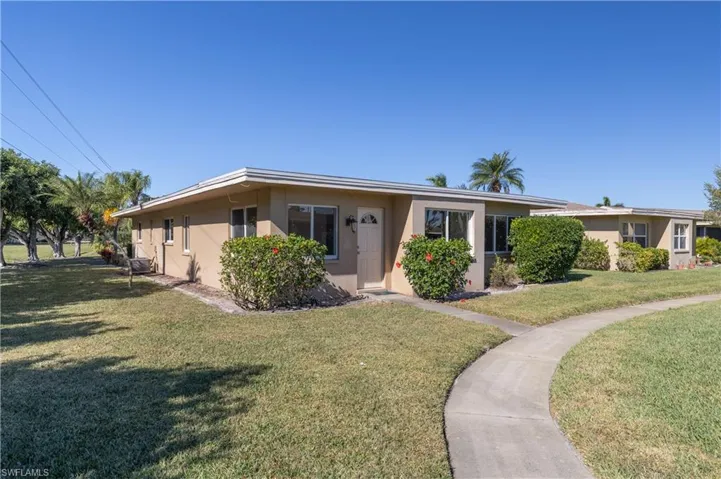 Single story home with stucco siding and a front lawn