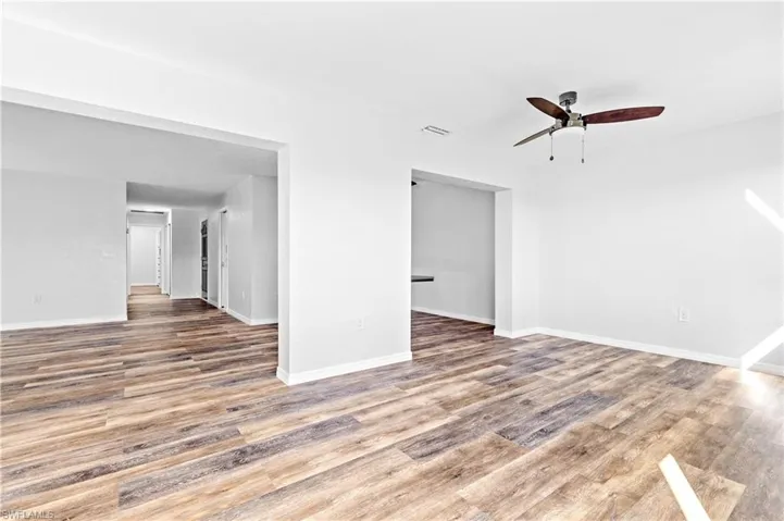 Unfurnished living room featuring light wood-type flooring and a ceiling fan