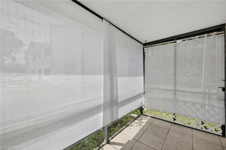 Unfurnished sunroom featuring tile patterned floors
