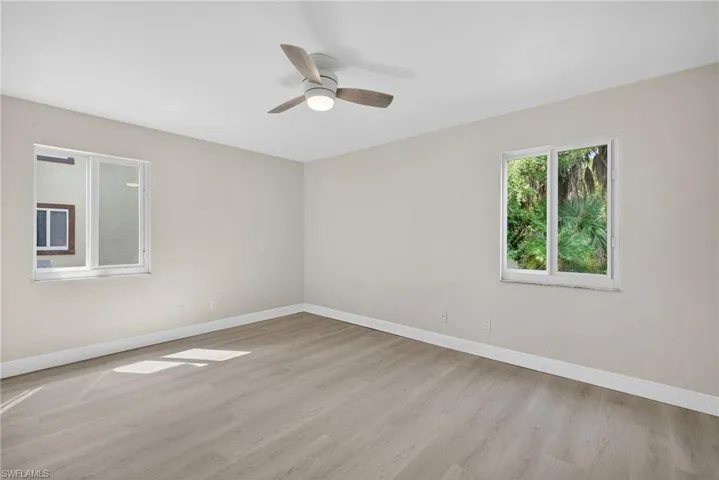 Empty room with light wood finished floors and ceiling fan