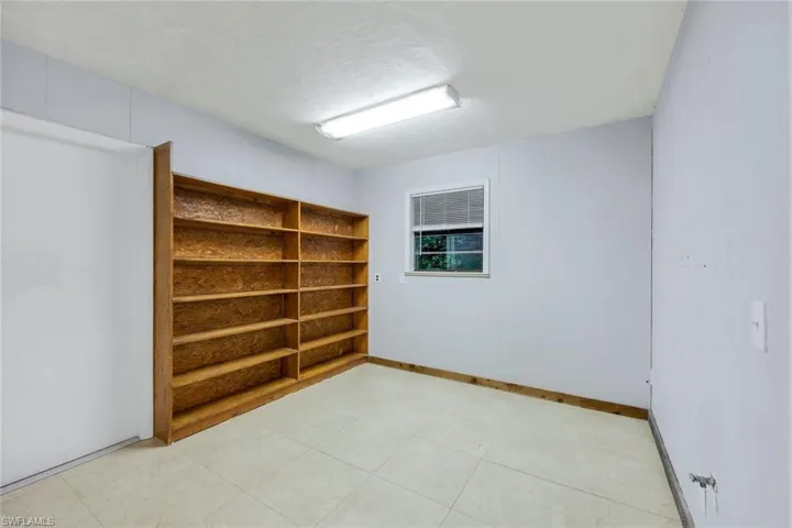 Unfurnished room with light tile floors