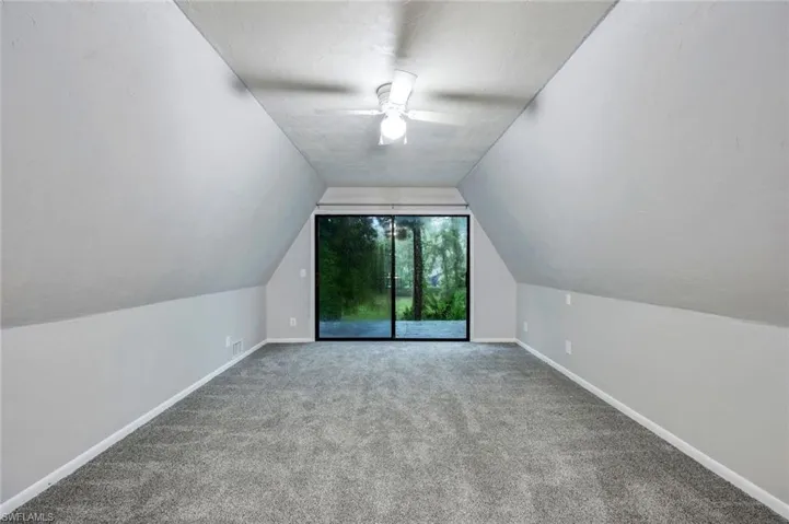 Bonus room with ceiling fan, carpet floors, and lofted ceiling