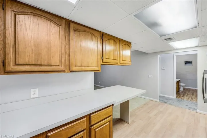 Kitchen featuring light hardwood / wood-style floors and a drop ceiling