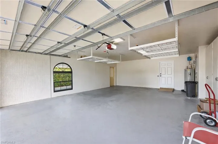 Spacious garage with extended storage and room for multiple vehicles, workshop setup, or accessible entry transition