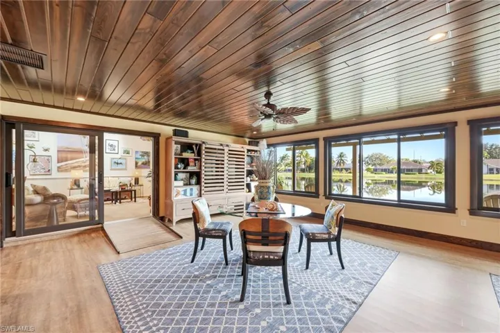 Enclosed sunroom with panoramic lake views and impact windows, designed for year-round living and everyday comfort