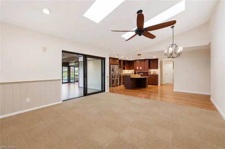 Family room with access to sunroom and kitchen (ai generated to remove furniture)