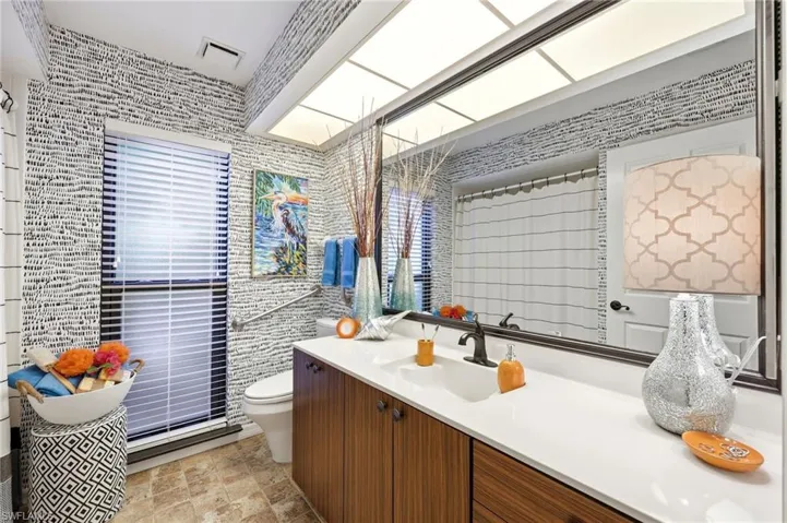 Full bathroom with walk-in shower, wide layout, and design supporting ease of movement and long-term living