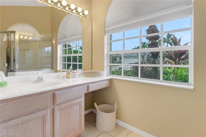 Full bath featuring vanity, tile patterned floors, and a shower with shower door