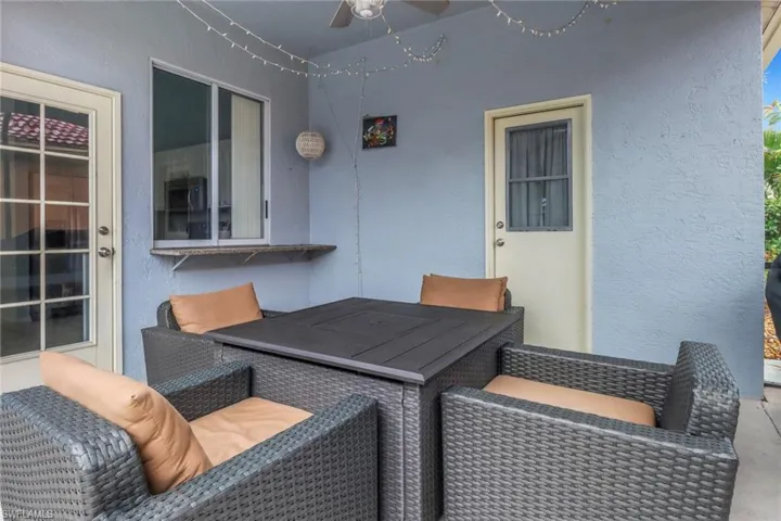 View of patio with a ceiling fan and outdoor dining space