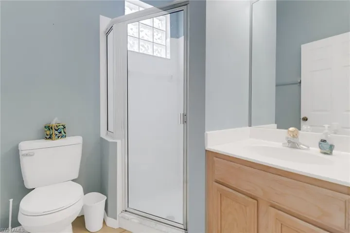 Bathroom featuring vanity and a shower stall