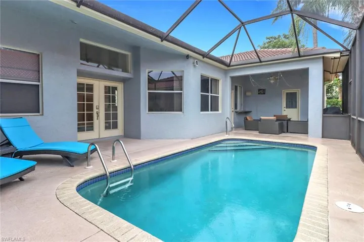 Swimming pool with french doors, a patio, and ceiling fan