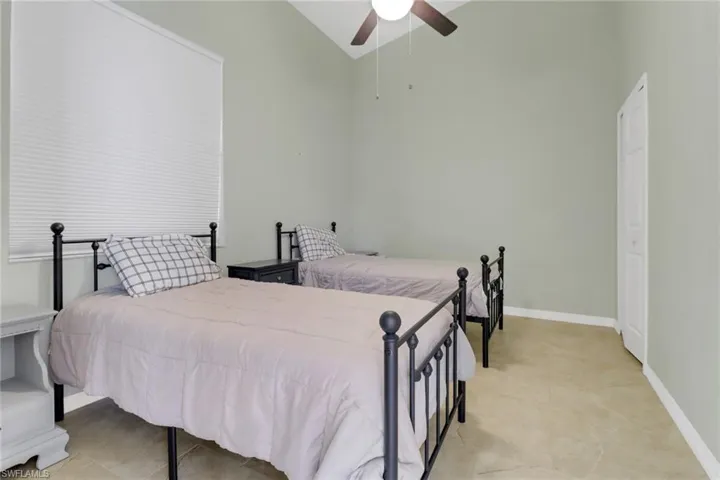 Bedroom featuring vaulted ceiling and a ceiling fan