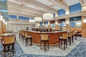 Bar area featuring beamed ceiling