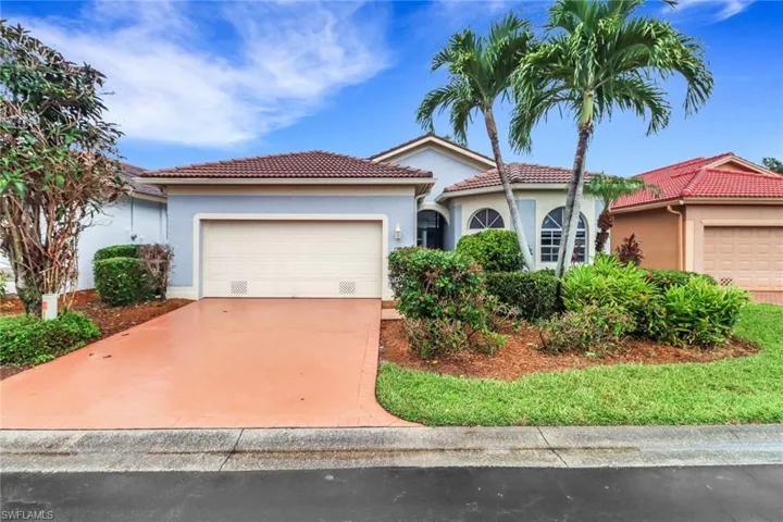 Mediterranean / spanish-style home featuring a garage, stucco siding, a tile roof, and concrete driveway