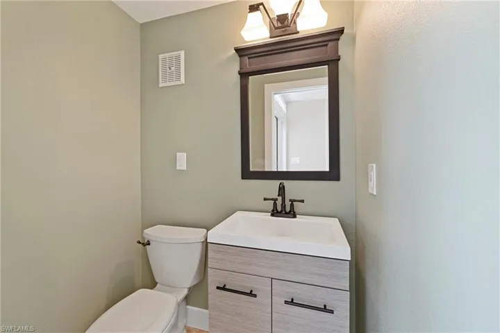 Bathroom featuring vanity and a textured wall