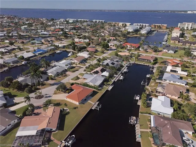 View of property location featuring a large body of water and nearby suburban area
