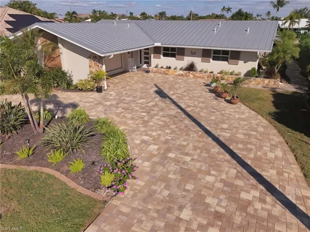 View of front of home featuring decorative driveway and stucco siding