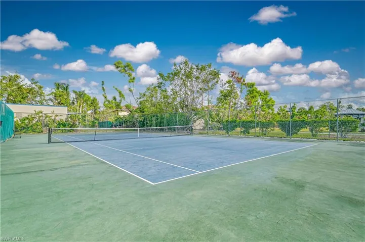 View of tennis court with fence