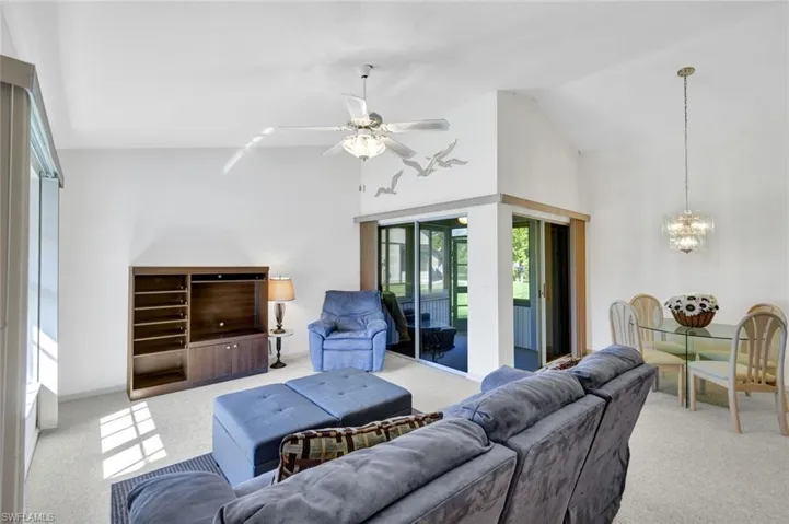Living room with view of dining area and screened sunroom