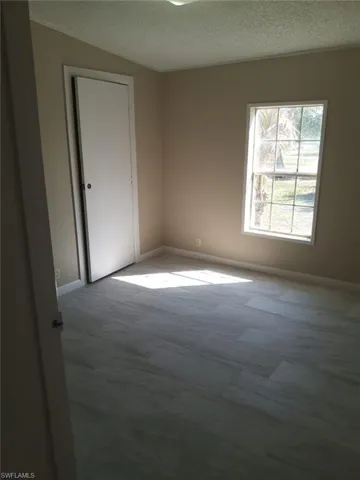 Unfurnished room with a textured ceiling and carpet