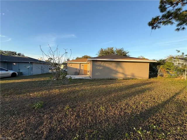 View of home's exterior featuring a patio and a lawn